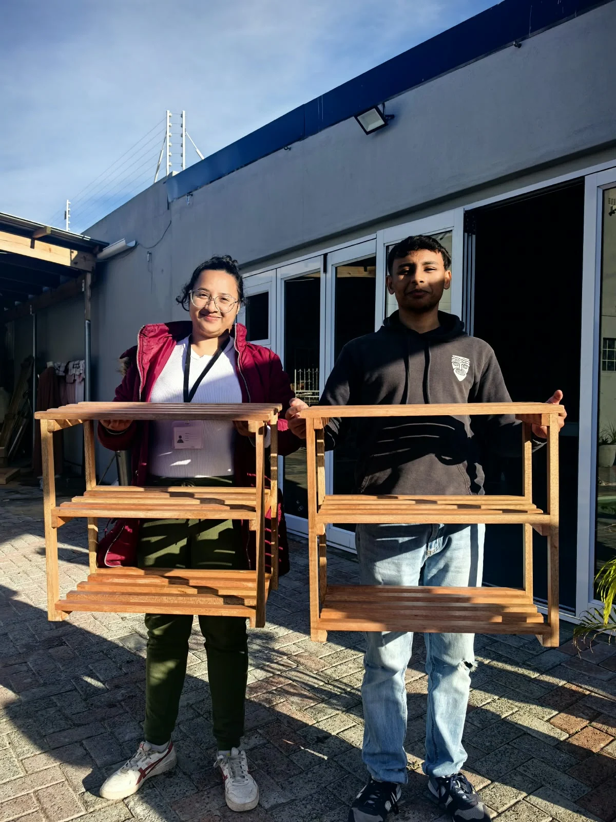 I Deserve It carpentry learners showing wooden pieces they made